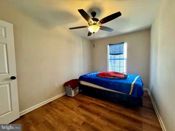 a room with a bed and a ceiling fan