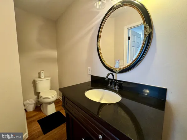 a bathroom with a sink a toilet and a mirror