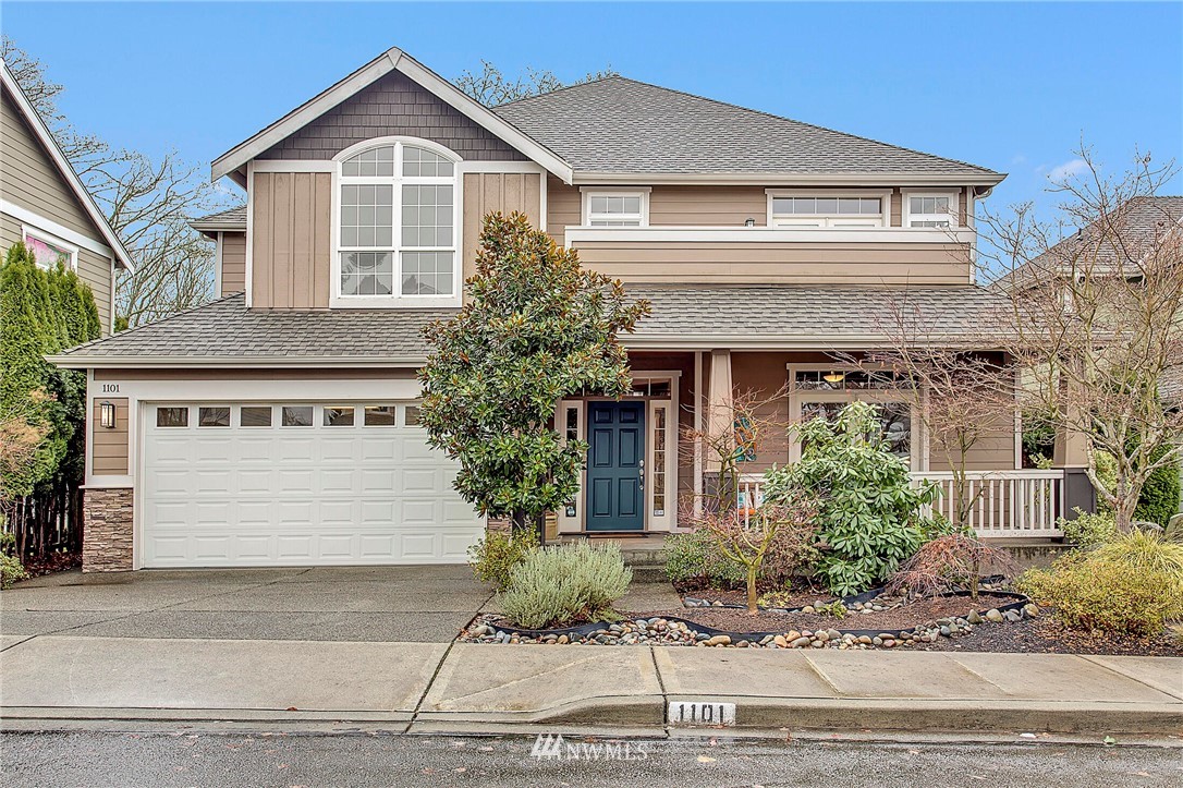 1101 North 27th Place Renton, WA 98056 - Photo 1 of 28 a front view of a house with a yard and garage