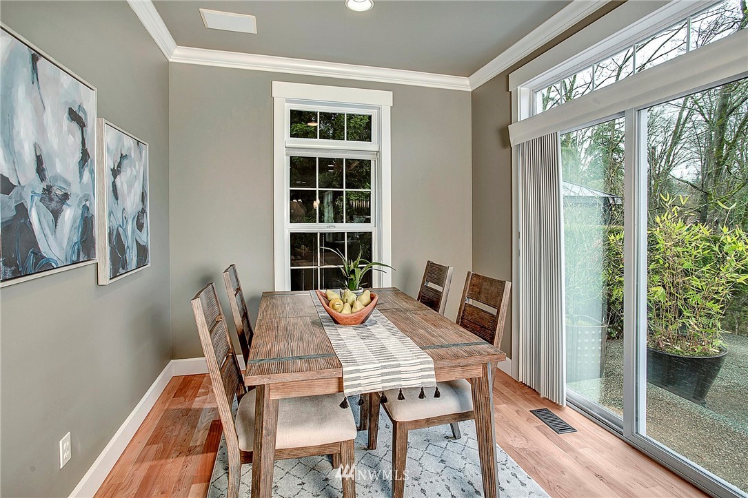 1101 North 27th Place Renton, WA 98056 - Photo 12 of 28 a view of a dining room with furniture window and wooden floor