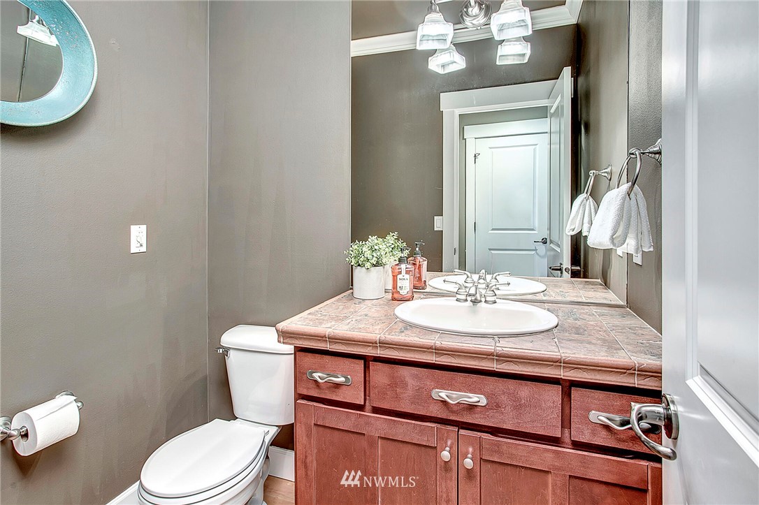 1101 North 27th Place Renton, WA 98056 - Photo 13 of 28 a bathroom with a granite countertop toilet sink and mirror