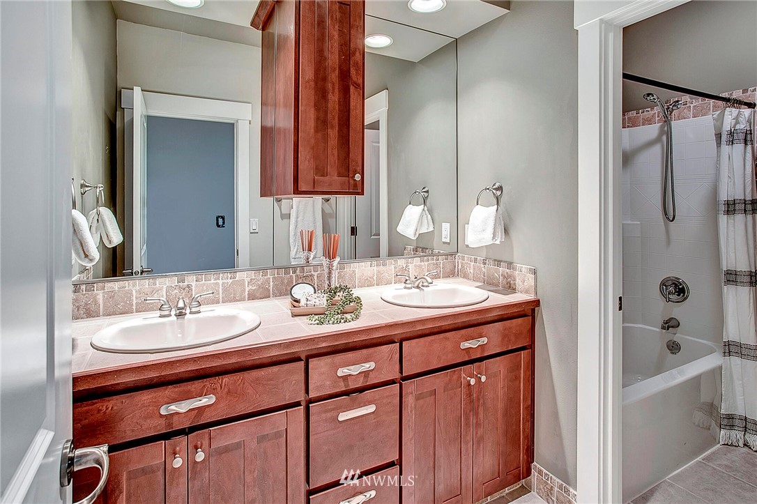 1101 North 27th Place Renton, WA 98056 - Photo 18 of 28 a bathroom with a granite countertop sink and a mirror