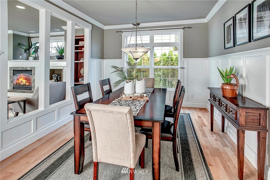 1101 North 27th Place Renton, WA 98056 - Photo 6 of 28 a dining room with furniture a chandelier and wooden floor
