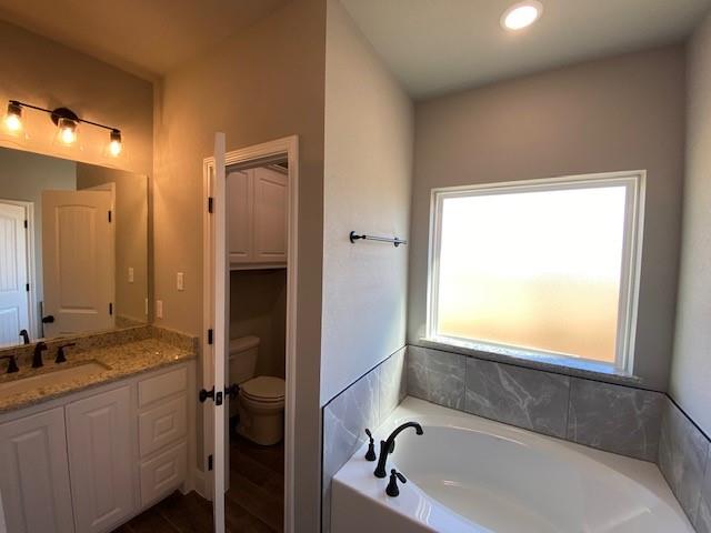 165 Coalson Crossing Azle, TX 76020 - Photo 17 of 23 a bathroom with a bathtub and a sink