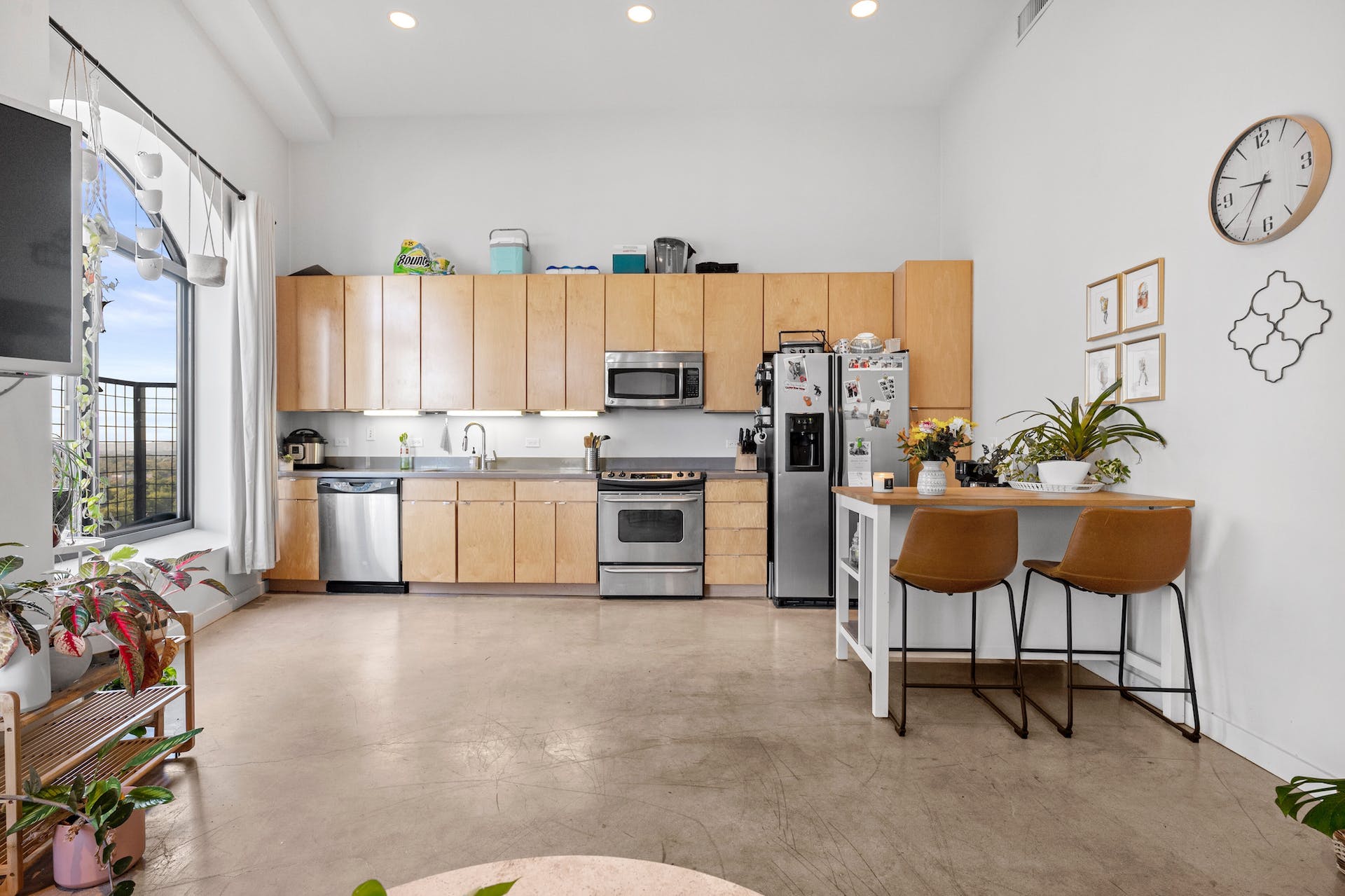 507 Sabine Street, Unit 908 Austin, TX 78701 - Photo 7 of 26 a kitchen with cabinets and chairs