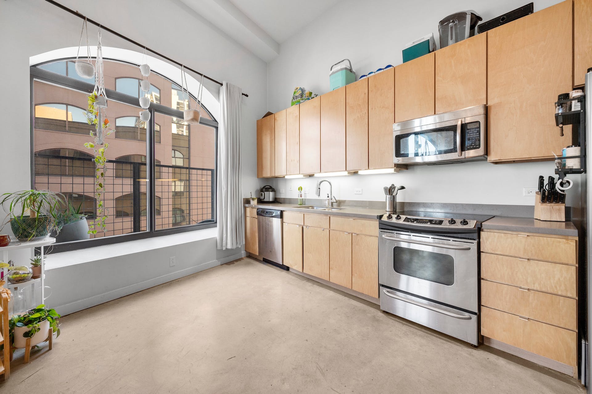 507 Sabine Street, Unit 908 Austin, TX 78701 - Photo 8 of 26 a kitchen with stainless steel appliances a stove a sink and a microwave