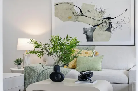 a living room with furniture and flowers