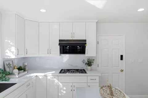 a kitchen with a stove and cabinets