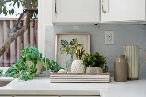 a vase of flowers sitting on a floor