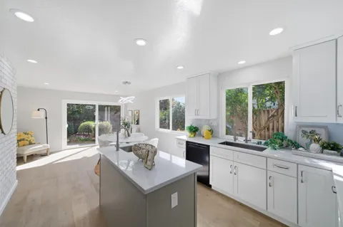 a kitchen with sink attached with living room