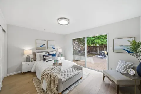 a bedroom with a bed and a large window