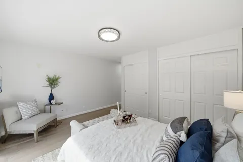 a bedroom with a bed and a couch