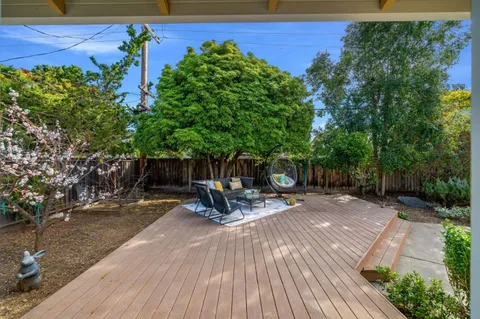 a view of a backyard with sitting area