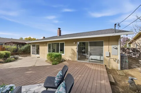 a front view of house with yard outdoor seating and wooden floor