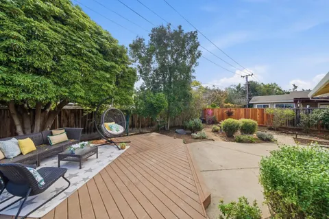 a view of a backyard with sitting area