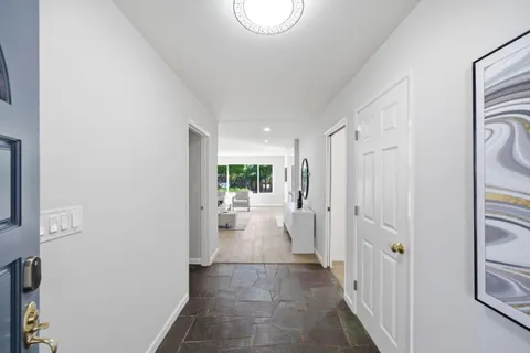 a view of a hallway with dining area and glass door