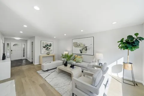 a living room with furniture and a potted plant