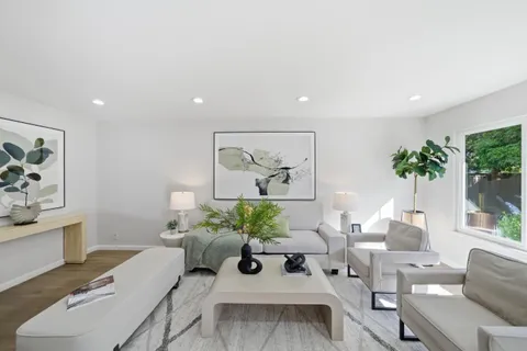 a living room with furniture and a potted plant