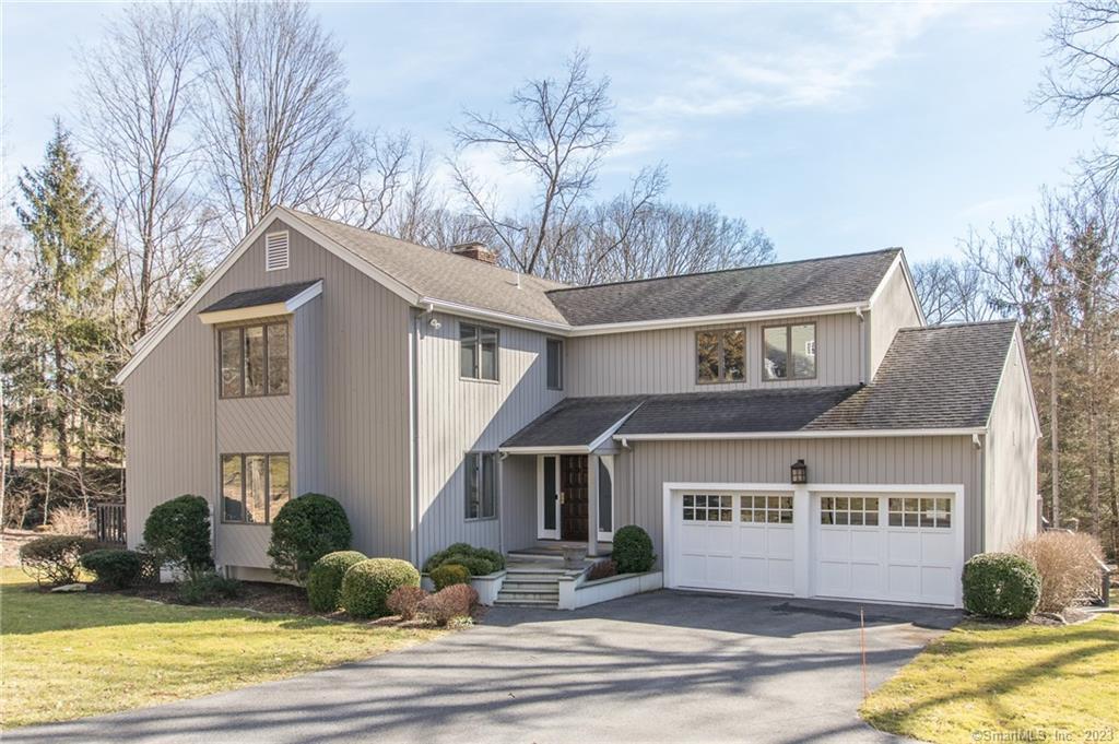 18 Spicewood Road Wilton, CT 06897 - Photo 1 of 1 a front view of a house with a yard and garage