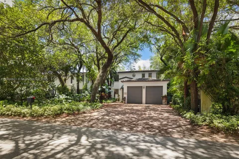 a view of a house with a tree in front of it