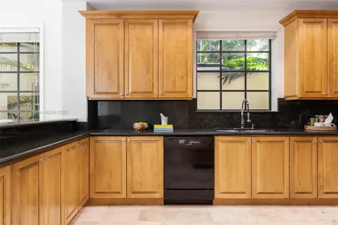 a kitchen with stainless steel appliances granite countertop a sink and cabinets
