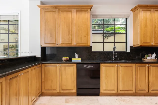a kitchen with stainless steel appliances granite countertop a sink and cabinets