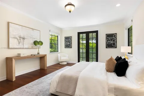 a bedroom with a large bed and a window