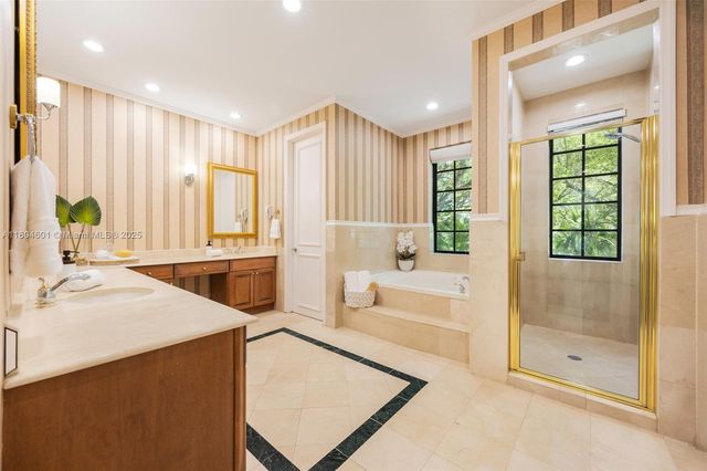 a spacious bathroom with a tub shower and sink