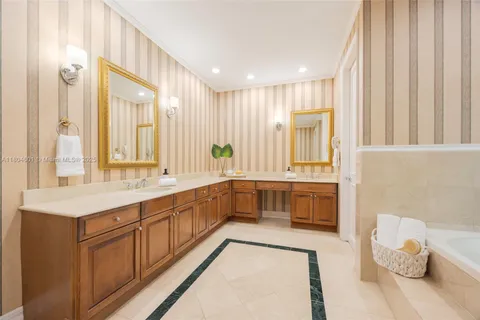 a large white bathroom with a large tub and sink