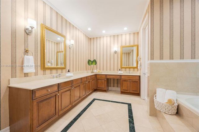 a large white bathroom with a large tub and sink