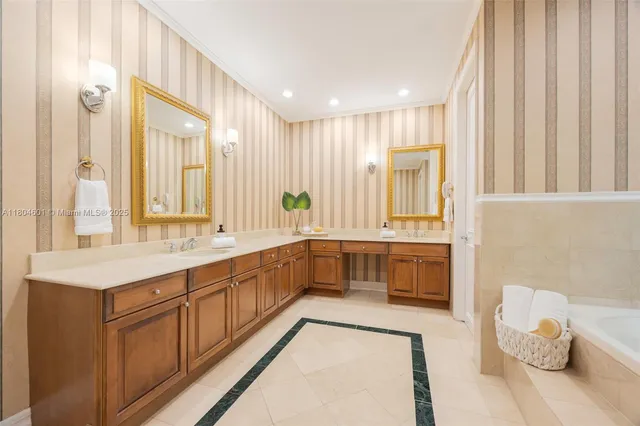 a large white bathroom with a large tub and sink