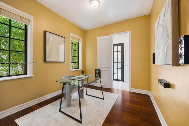 a room with chandelier fan and windows