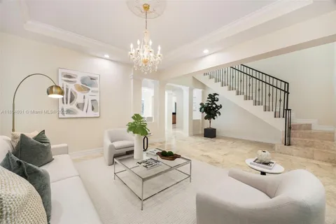 a living room with furniture and a chandelier