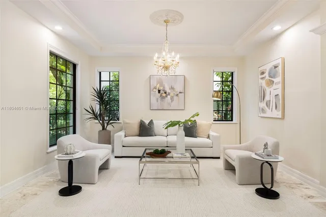 a living room with furniture and a chandelier