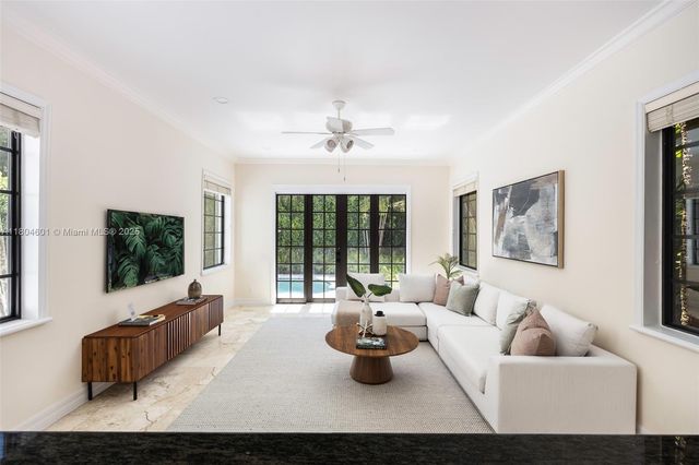a living room with furniture and a flat screen tv