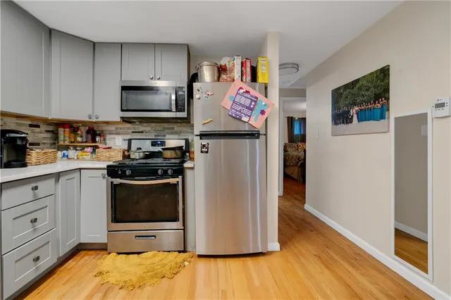 a kitchen with stainless steel appliances a stove microwave and refrigerator