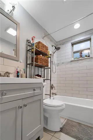 a bathroom with a toilet a sink and bathtub