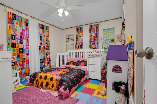 a bedroom that has a bed and a baby bed