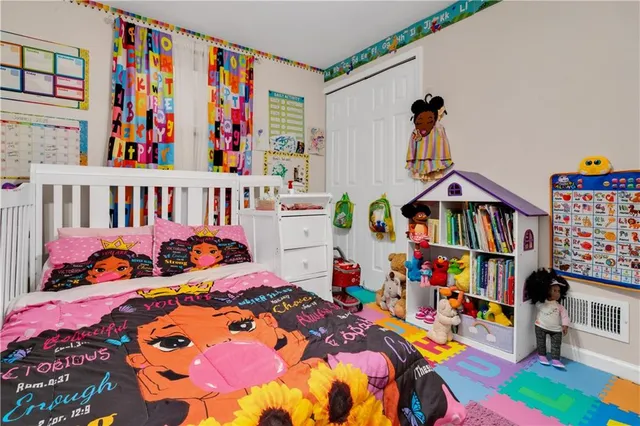 a kids room that has a bed and a dresser in it