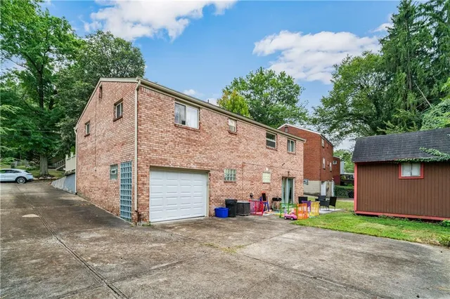 a view of a house with a yard and a garage