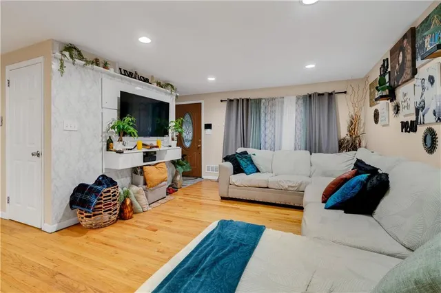 a living room with furniture and a flat screen tv