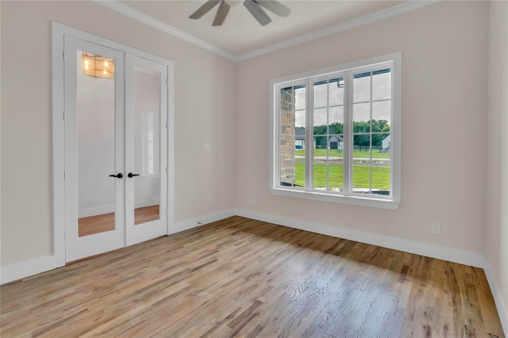 1028 Henry Way Springtown, TX 76082 - Photo 6 of 40 an empty room with wooden floor and windows