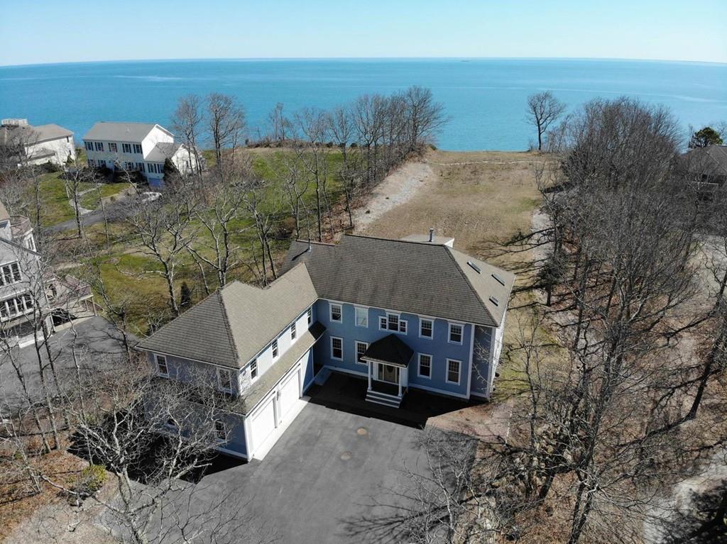 an aerial view of a house with garden space and ocean view