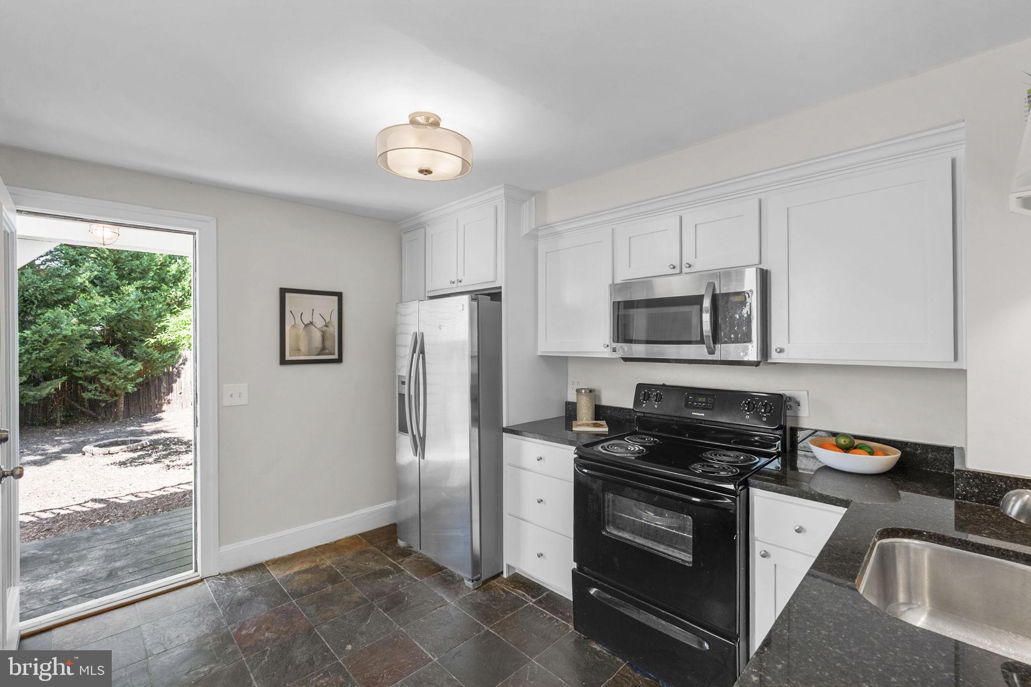914 15th Street Southeast Washington, DC 20003 - Photo 11 of 37 a kitchen with stainless steel appliances granite countertop a refrigerator stove and sink