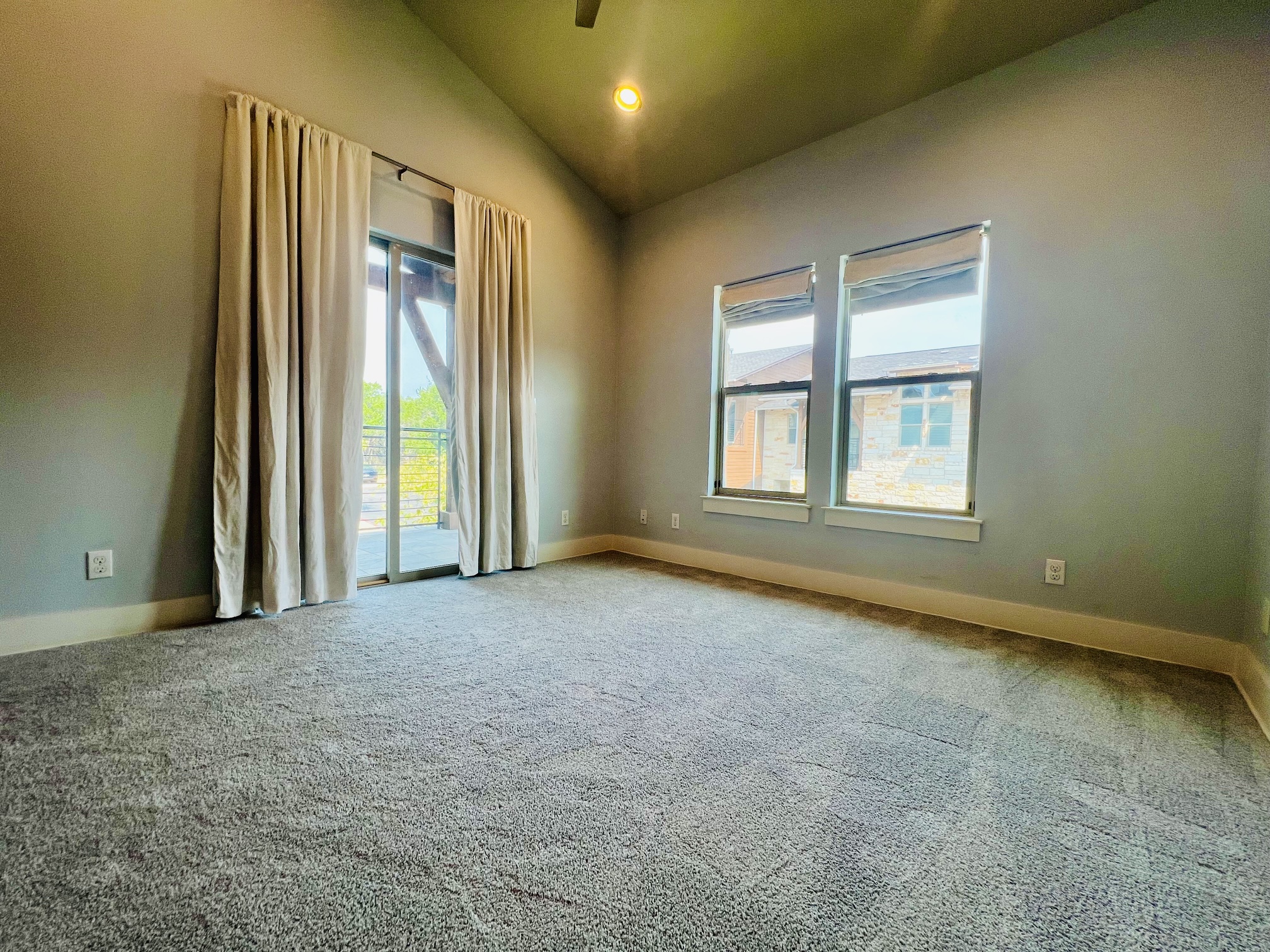 8110 Southeast Ranch Road 2222, Unit 98 Austin, TX 78730 - Photo 15 of 31 High vaulted ceilings and soft carpeting define this versatile space leading out to a private balcony.