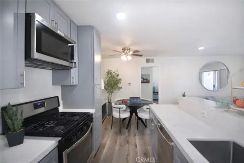 a kitchen with a sink stainless steel appliances and cabinets