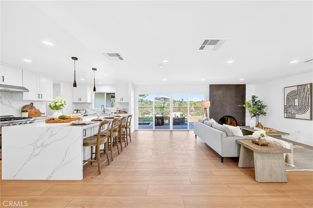 930 Rancho Circle Fullerton, CA 92835 - Photo 18 of 57 a living room with furniture a rug kitchen view and a large window