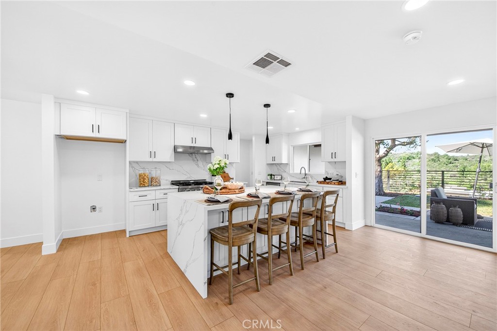 930 Rancho Circle Fullerton, CA 92835 - Photo 20 of 57 a kitchen that has a lot of cabinets a sink and appliances in it