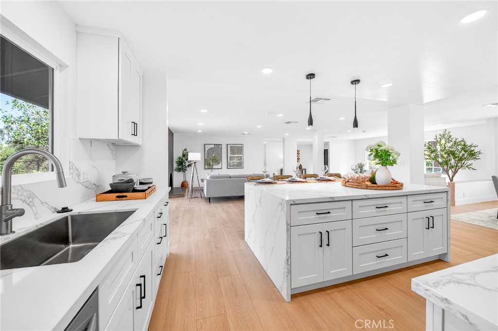930 Rancho Circle Fullerton, CA 92835 - Photo 23 of 57 a large kitchen with stainless steel appliances a lot of counter space and wooden floor