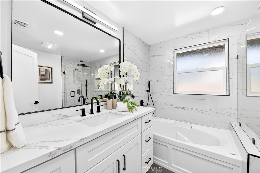 930 Rancho Circle Fullerton, CA 92835 - Photo 34 of 57 a bathroom with a sink tub vanity and a mirror